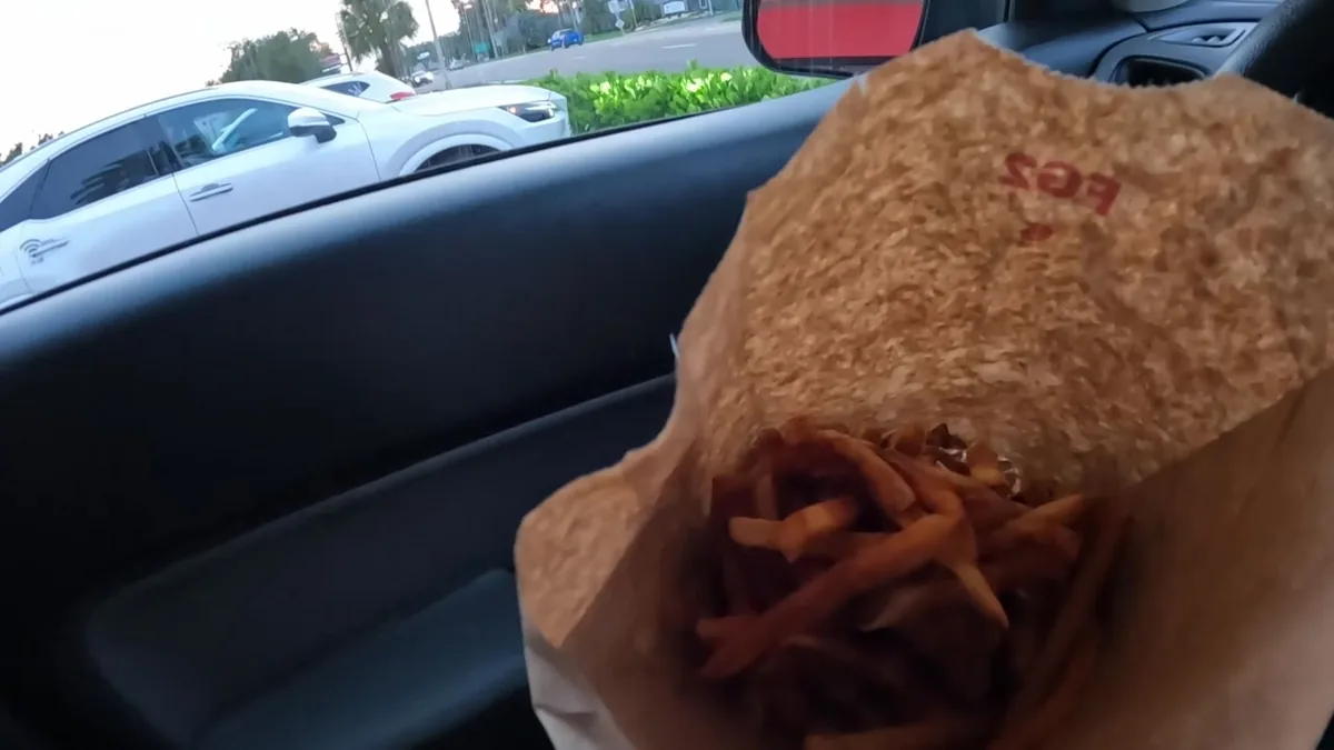 A Five Guys meal and an overflowing bag of Cajun fries