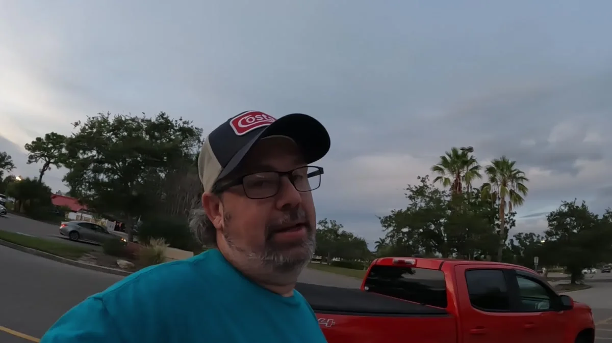 Derek beside his truck at dusk during Day 94